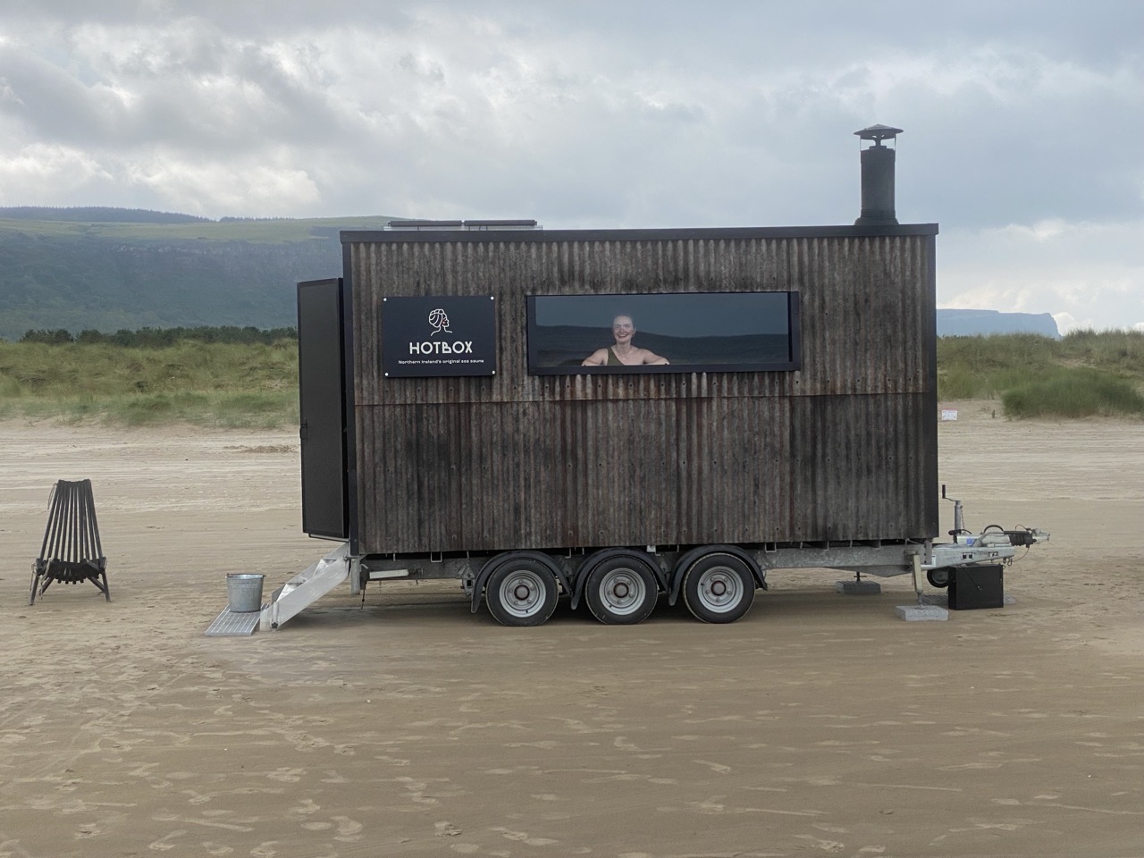 The sauna on the beach with Lucy at the window.