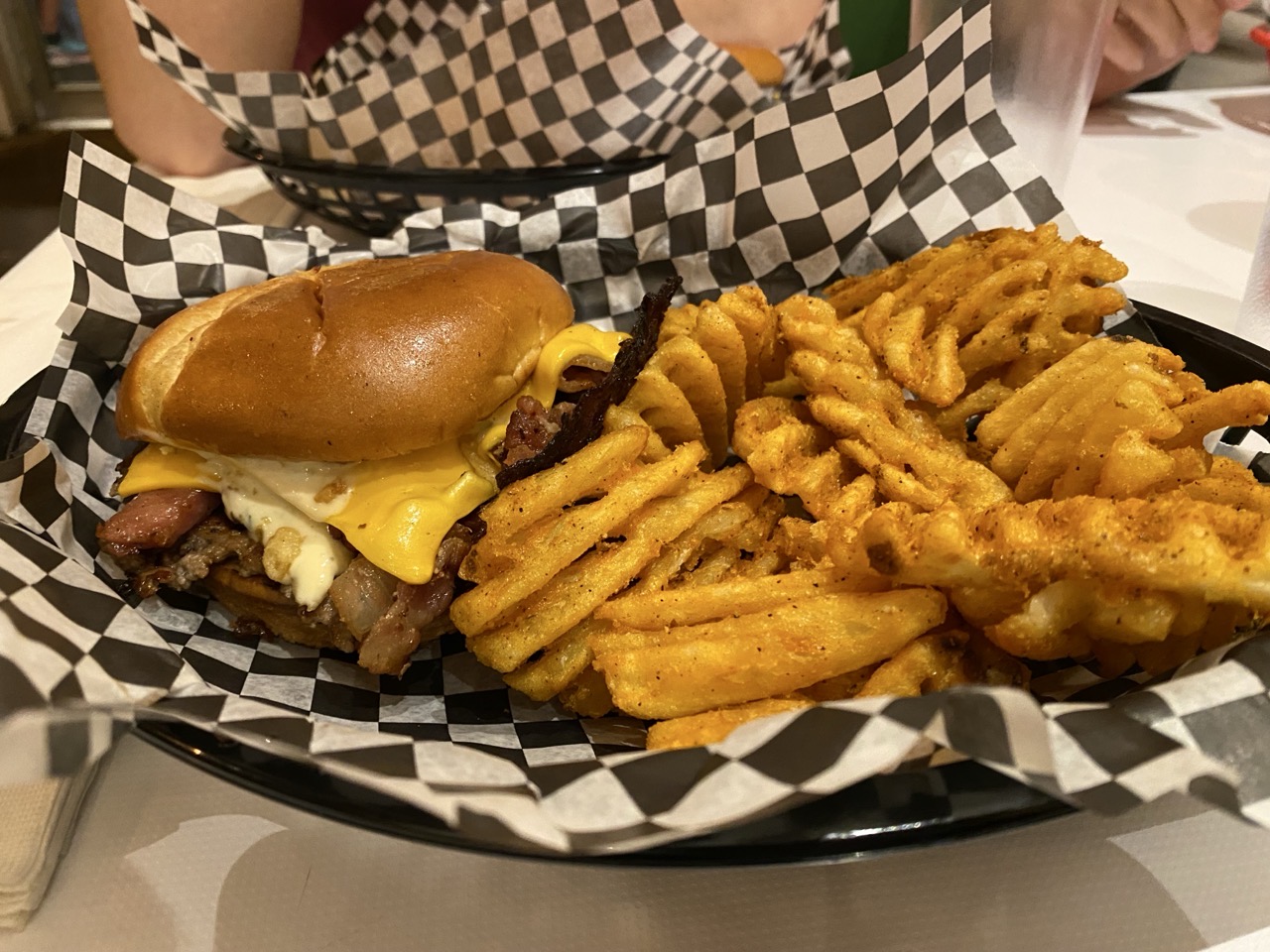 A burger and waffle fries from Between Two Buns.