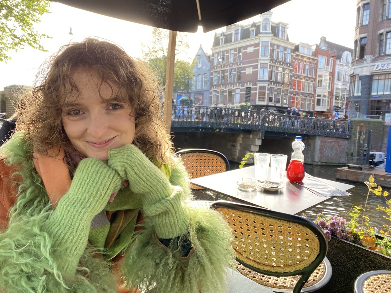 Lucy with a canal and a little table in the background