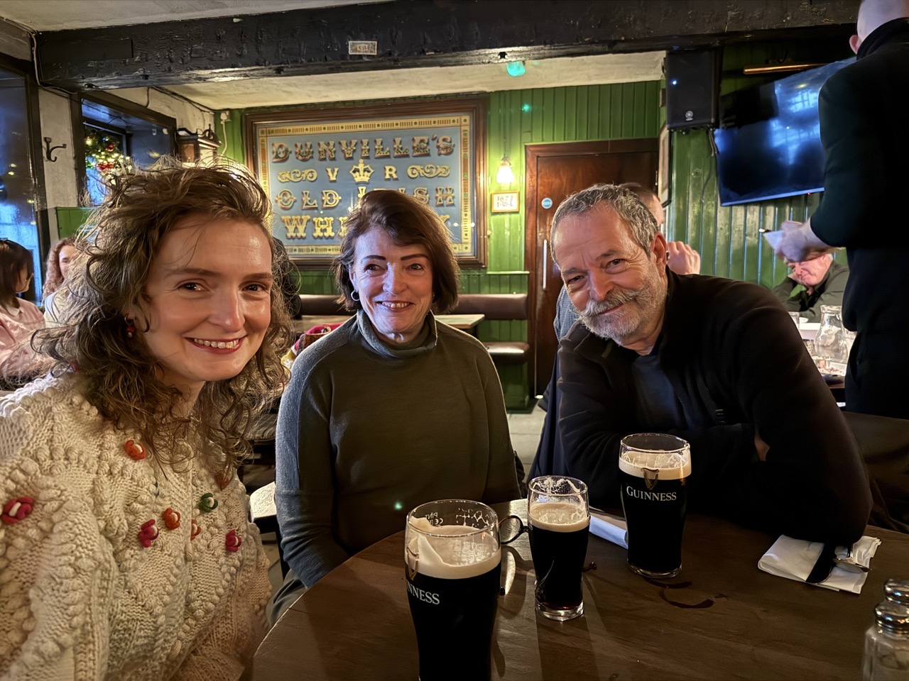 Lucy and her parents in White’s tavern with pints of Guinness.