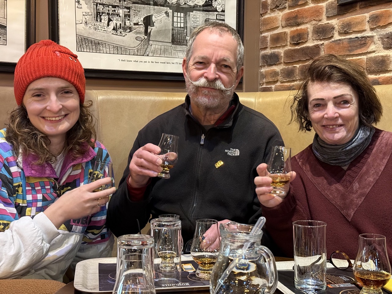 Lucy and her parents with whiskey at Bushmills