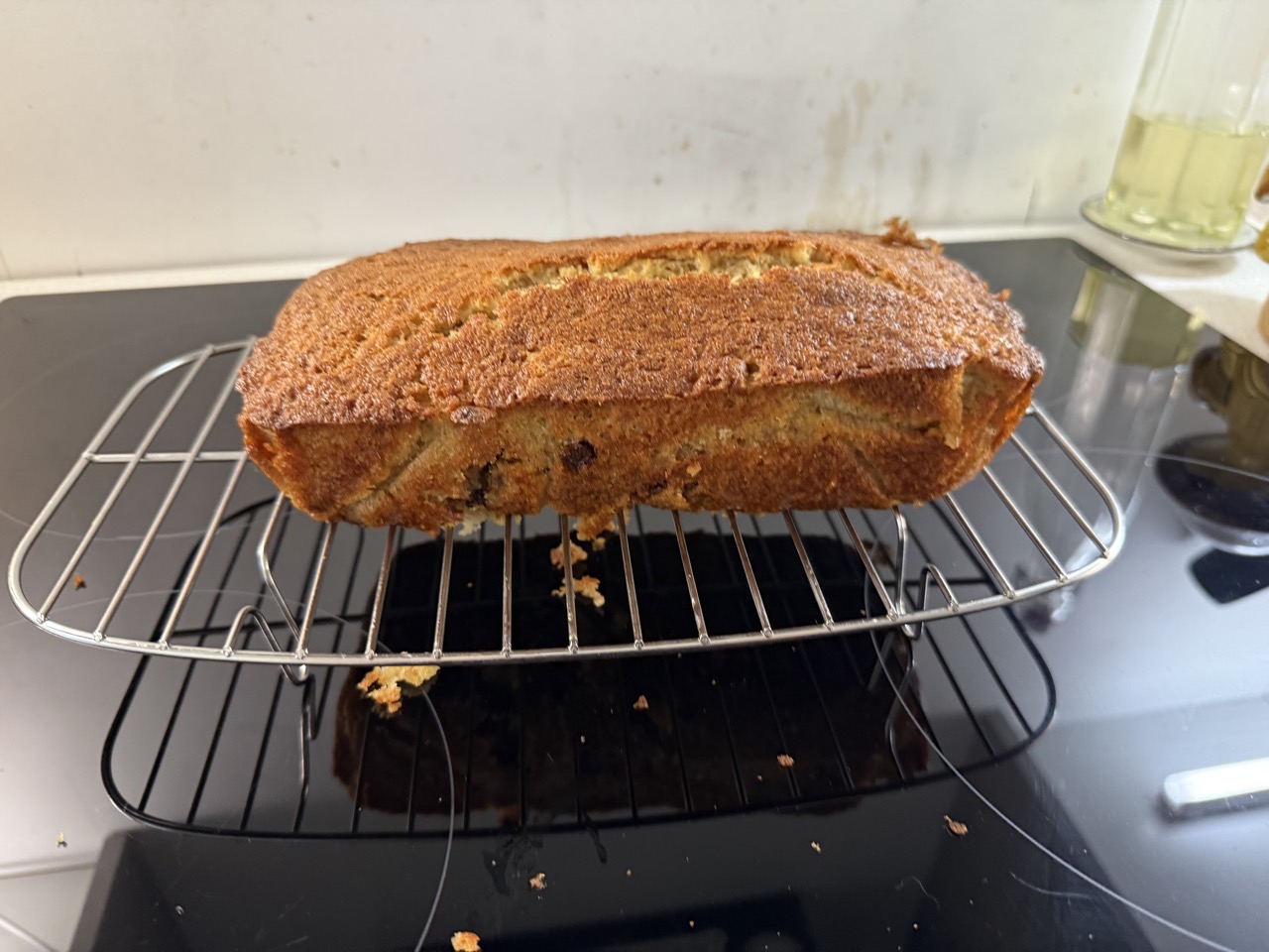 Banana bread on a wire rack. The top is nice and crisp, the bottom less so